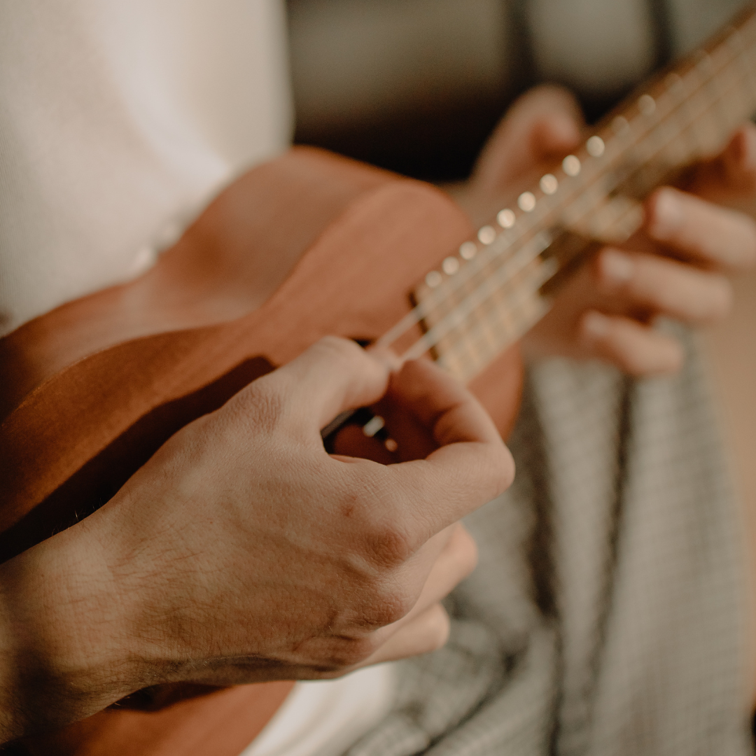 Close up of hand strumming a ukulele 